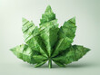 A green origami creation resembling a cannabis leaf on a white background, showcasing intricate folding craftsmanship.