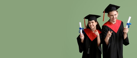 Wall Mural - Happy graduating students on green background with space for text