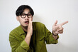 © ARIF MIFTAHUL ANWAR - Adult Asian man doing whisper gesture isolated white background