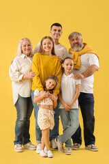 Poster - Big family hugging on yellow background