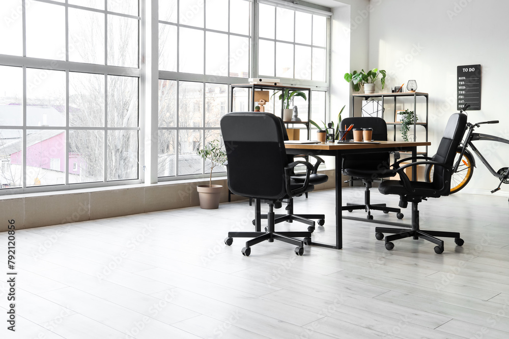 Interior of office with table prepared for business meeting