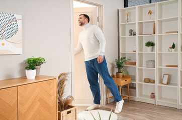 Poster - Young man opening door in living room