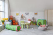 Interior of modern children's room with table and play tunnel