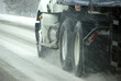 Speeding truck wheels on icy road
