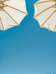 Two White Umbrellas on Sandy Beach