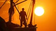 Silhouetted against the rising sun a fisherman stands proudly on the bow of his boat surrounded by the spoils of a fruitful day at sea. .