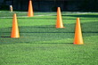 artificial green grass soccer field with orange training cones