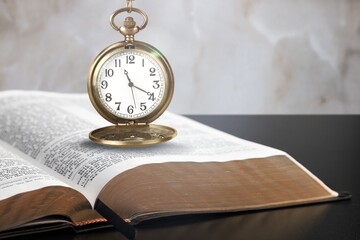 Wall Mural - The old retro clock lies on book.