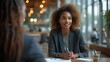 © Jeff - Smiling  and confident African American female in a business meeting - conference room table - blurred background