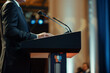 Close-up of a multinational CEO giving a speech at an international economic forum, company logo on the podium