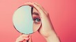 © Aris Suwanmalee - A woman looking through magnifying glass.