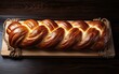 Freshly baked braided bread on wooden background. Top view.