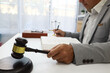© weerachai - Lawyer siting at in Law office Justice law and wooden gavel tool on desk .concept