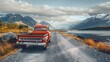 A pickup truck pulls a vintage red long-tail boat on a beautiful road. On the side is the water's edge, with mountains shining with light. color saturation