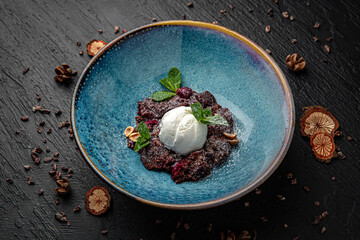 Wall Mural - Dessert broken brownies with ice cream. Menu for a pub on a dark background. Colorful juicy food photography.