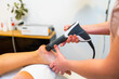 © unai - Patient receiving a shockwave therapy massage on foot