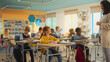 © Gorodenkoff - Class of Adorable Multiethnic Children Listening to a Lecture from a Teacher and Writing Down Notes in an International Elementary School. Enthusiastic Female Explains New Subjects to Young Smart Kids