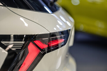 Wall Mural - Rear red stop signal lamp on a modern car. Close-up. Selective focus.