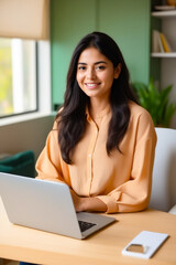 Wall Mural - Woman sitting at table with laptop computer.