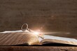 image of open book with vintage key on wooden table