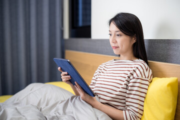 Poster - Woman look at tablet computer on bed