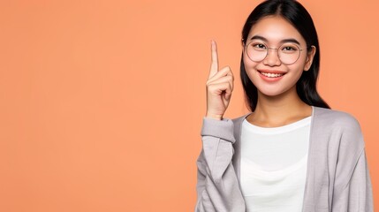 Wall Mural - beautiful asian woman smiling pointing empty space