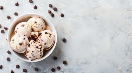 Canvas Print - Bowl of chocolate chip ice cream with scattered chocolate chips on a light background.