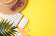 Top-view image combining work and leisure with a keyboard and beach accessories on a sunny yellow backdrop, ideal for remote work during the summer season