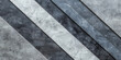 A series of gray and black stripes are arranged in a row. The stripes are of varying widths and are separated by small gaps. The overall effect is a sense of depth and texture