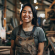 Woman carpenter smiling camera, factory background.