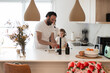 © ADDICTIVE STOCK - Father and daughter preparing food in modern kitchen