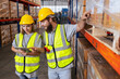 Male and Female professional worker wearing safety uniform using tablet inspect goods on shelves in warehouse. supervisor worker checklist stock inspecting product in storage for logistic.