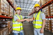 Male and Female professional worker wearing safety uniform shake hands and agree on work in warehouse. supervisor worker checklist stock inspecting product in storage for logistic.