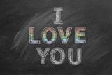 Fototapeta  - I love you. Inscription in chalk on the blackboard with rainbow colors. LGBT, LGBTQIA rights and gender equality concept. Pride month. Declaration of love, acceptance of feelings, giving love.