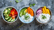 Four bowls with ranch dressing and raw vegetables
