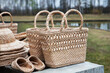 Straw-woven hats, baskets and bast shoes lie on the counter. Eco-friendly handmade products.	