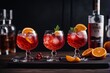 'two alcoholic cocktail gin tonic negroni black wooden background bar party orange red glasses alcohol drink food white beverage fruit ice citrous whiskey table spritz barkeeper green row closeup'