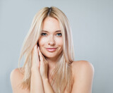 Fototapeta  - Cheerful woman face close-up. Blonde model with fresh clear skin and healthy silky hair on white background