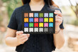 Photography model holding color checker board or colors chart for calibrate accurate colors photos or videos