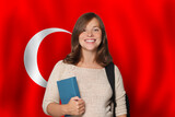 Fototapeta  - Happy woman student against Turkish flag background. Travel, education and learn language in Türkiye concept