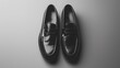 A stylish loafer mockup in a sophisticated black shade, positioned on a solid gray background, exuding elegance and refinement, all photographed in high-definition to emphasize its polished surface 