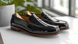 A stylish loafer mockup in a sophisticated black shade, positioned on a solid gray background, exuding elegance and refinement, all photographed in high-definition to emphasize its polished surface 