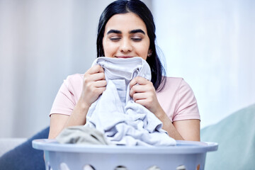 Poster - Woman, laundry and fresh smelling clothes on sofa for washing, hygiene and cleaning in apartment. Female person, fabric and cleaner in family home for routine, care and service in living room