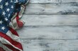American flag draped over white rustic wooden surface, symbolizing patriotism and national holidays