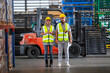 Male and Female professional worker wearing safety uniform inspect goods on shelves in warehouse. supervisor worker checklist stock inspecting product in storage for logistic.