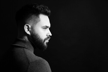 Wall Mural - Portrait of handsome bearded man on dark background, space for text. Black and white effect
