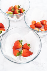 Sticker - Fresh and Moldy Strawberries in a Glass Bowl on a White Napkin