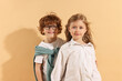 © New Africa - Fashion concept. Stylish children on pale orange background