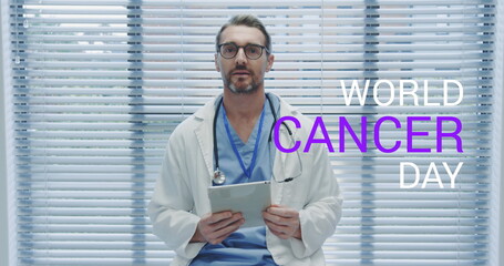 Sticker - Image of world cancer day over caucasian male doctor using tablet