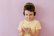 Boy with smartphone in headphones